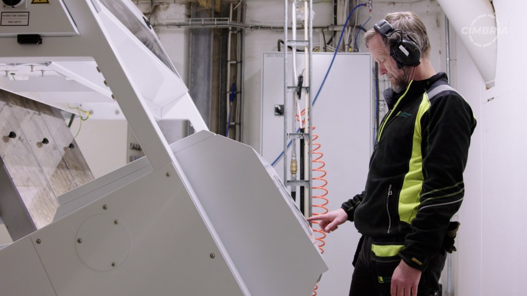 man using an optical sorter machine